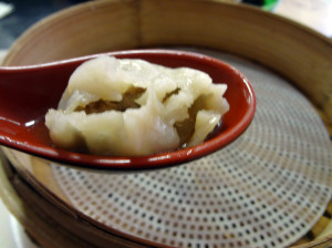 Shanghai pork soup dumpling with the top bitten off