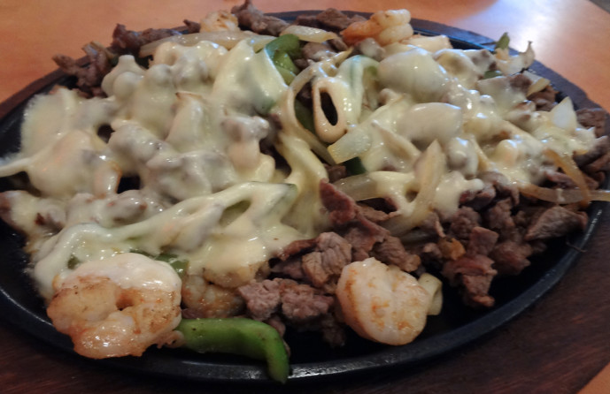 El Maremoto: grilled shrimp, steak, octopus, and squid with bell peppers, onions, and cheese.