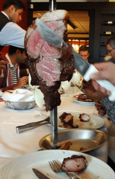 Fogo de Chao serving the meat