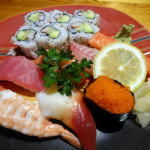Blurry photo of sushi and sashimi platter