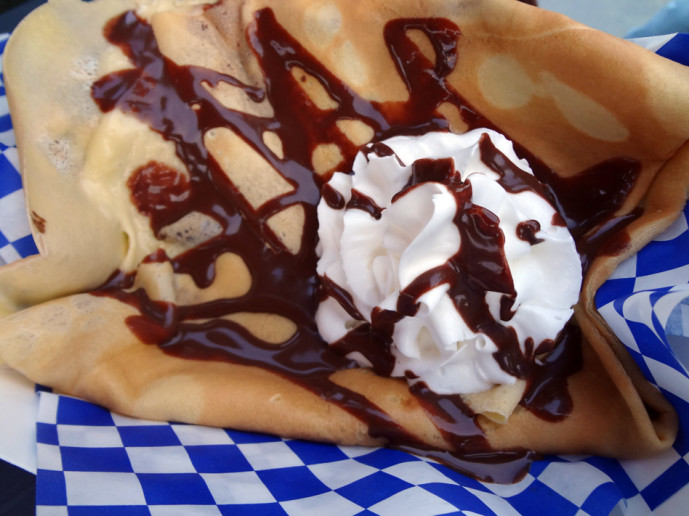 A sweet crepe with chocolate and whipped cream