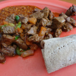 Steak tibs with injera and a side of miser wot